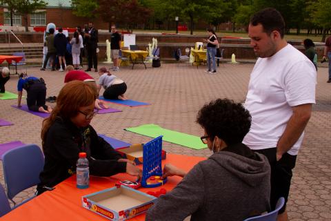 Daylight Hour 2023 Students are engaged in outdoor Daylight Hour activities such as games, yoga, class with Danny and art.